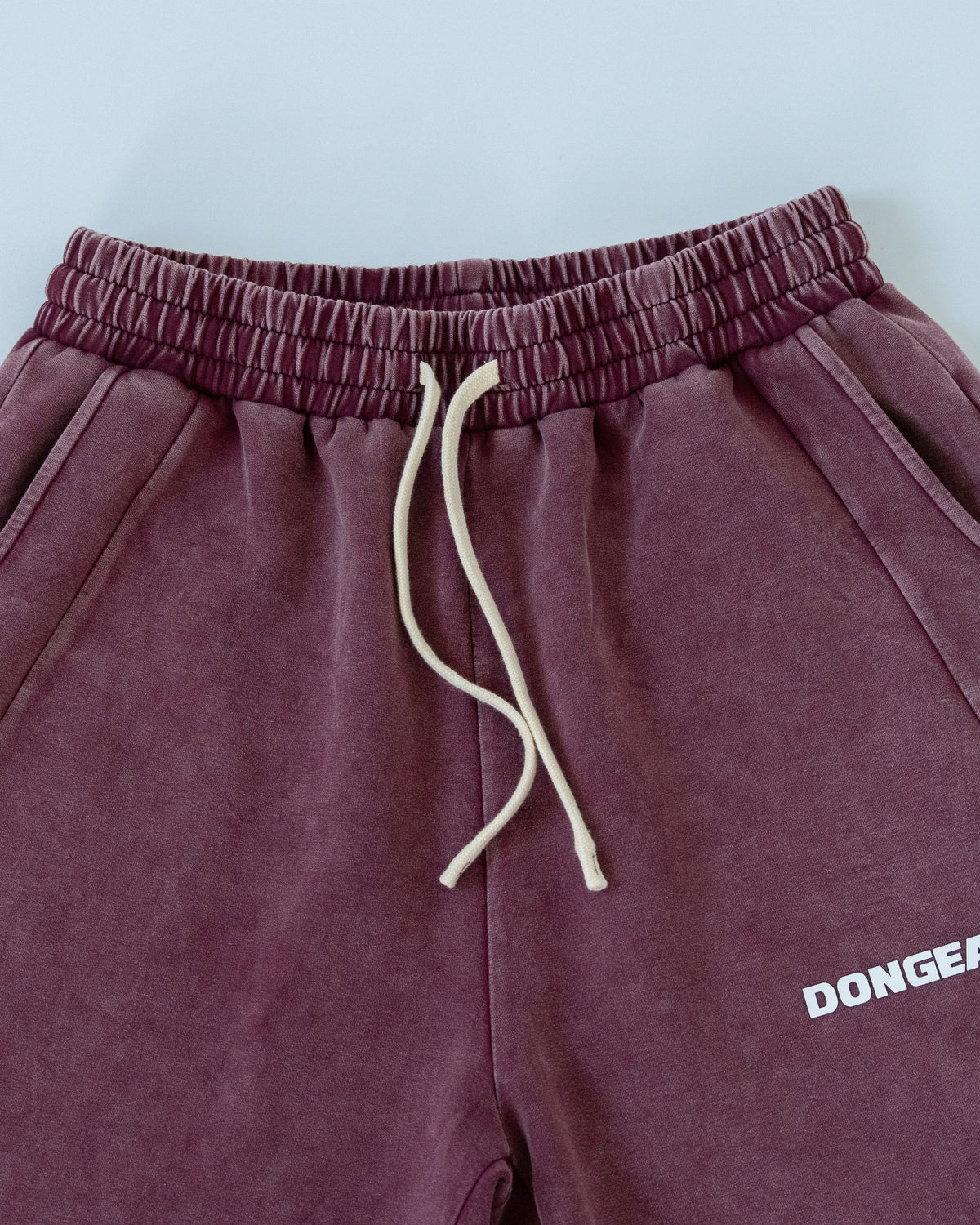 The Standard Shorts in Oxblood, detail of the waistband and drawcord