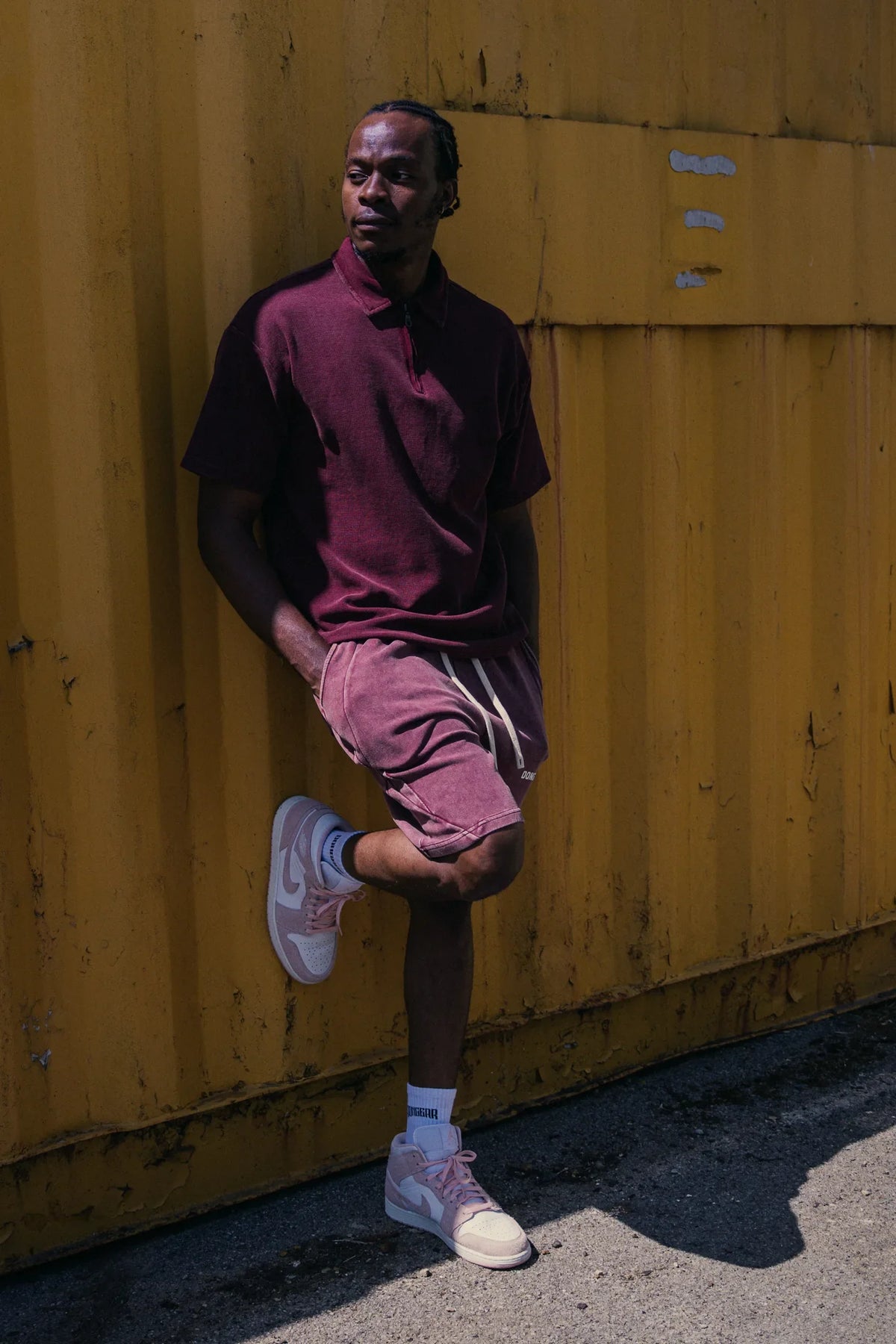 The Standard Zip Polo in Oxblood, worn with The Standard Shorts in Oxblood