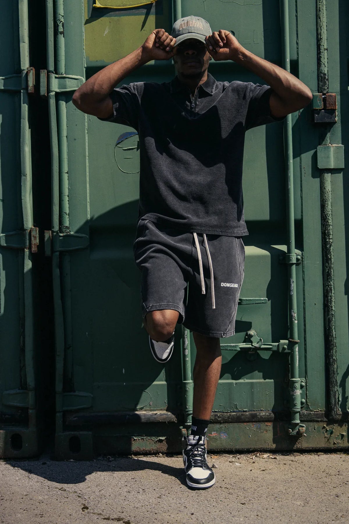 The Standard Shorts in Black, worn with The Standard Zip Polo in Black