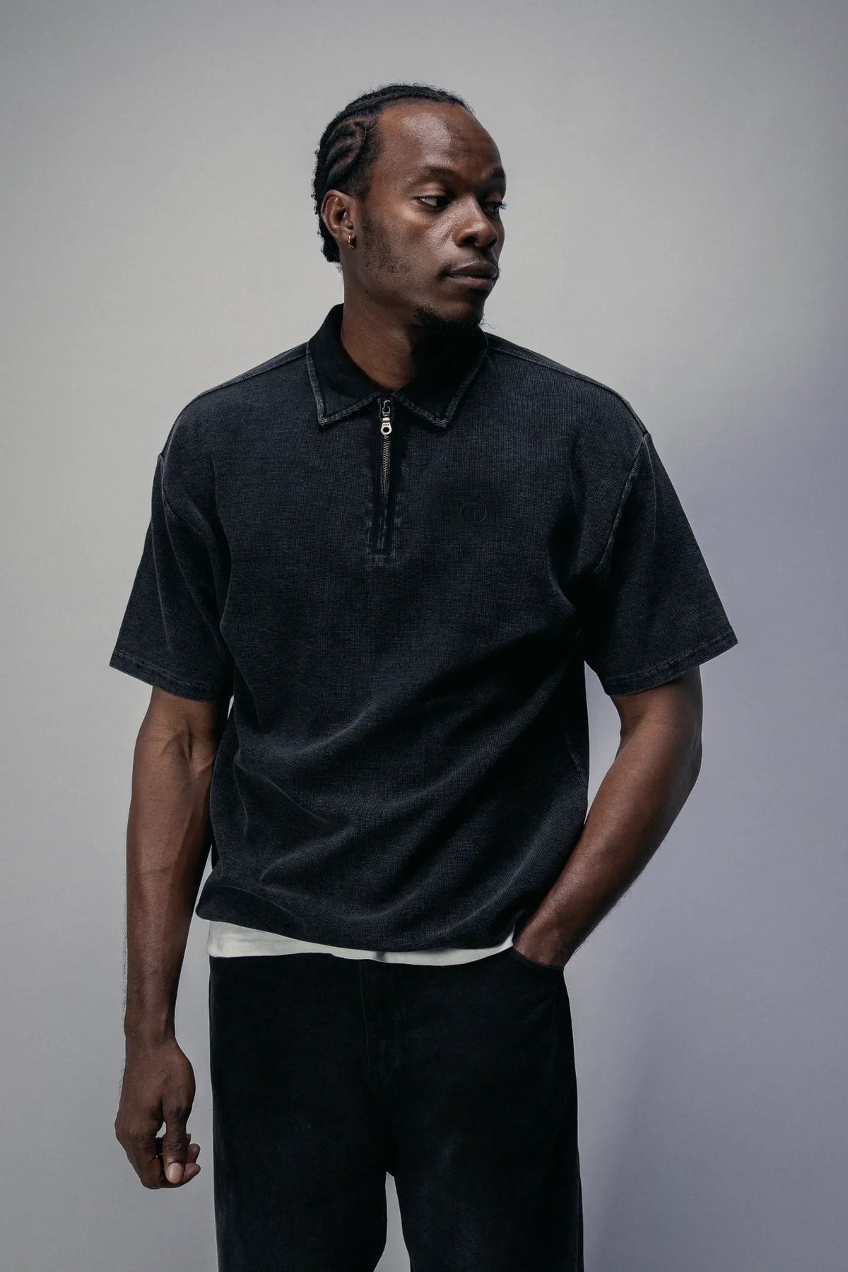 The Standard Zip Polo in Black, worn, front